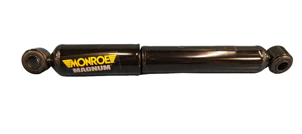 Monroe Magnum shock absorber on a blue surface